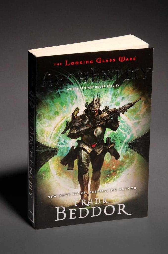 The paperback standing upright, photographed at an angle against a grey backdrop.