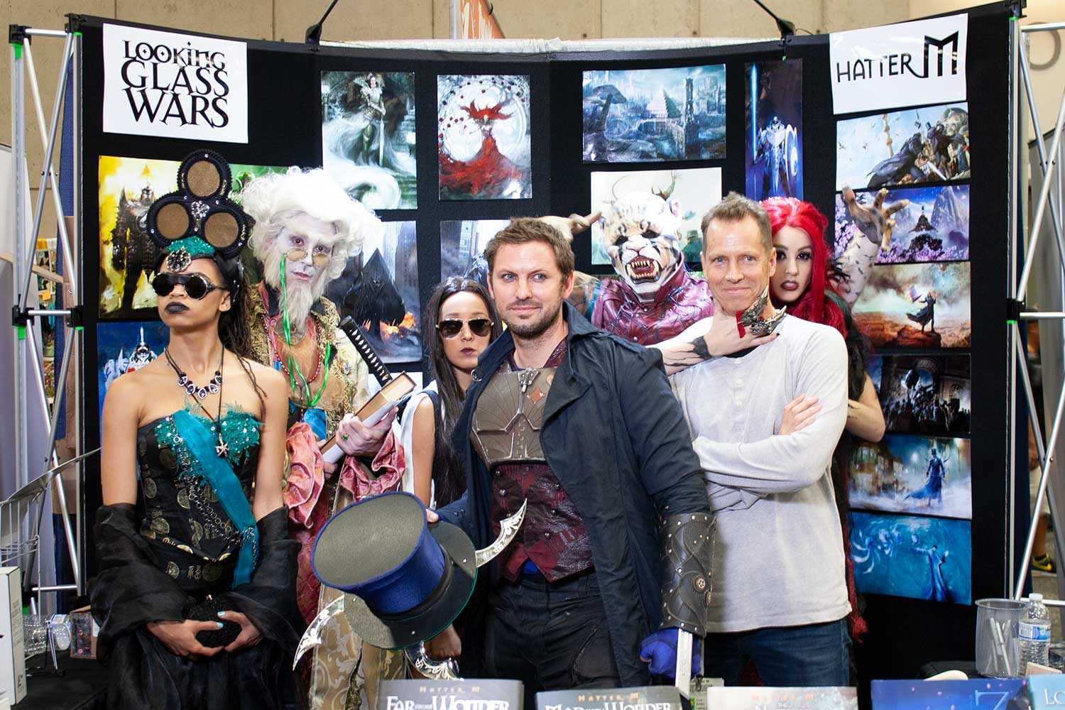 Beddor at the Looking Glass Wars and Hatter M booth, its walls
               hung with the books&rsquo; art, crowded in among
               cosplayers: a Hatter Madigan holding out his
               blade-rimmed top hat, a white-haired Bibwit
               Harte, a red-haired Redd and a cat-masked
               warrior.