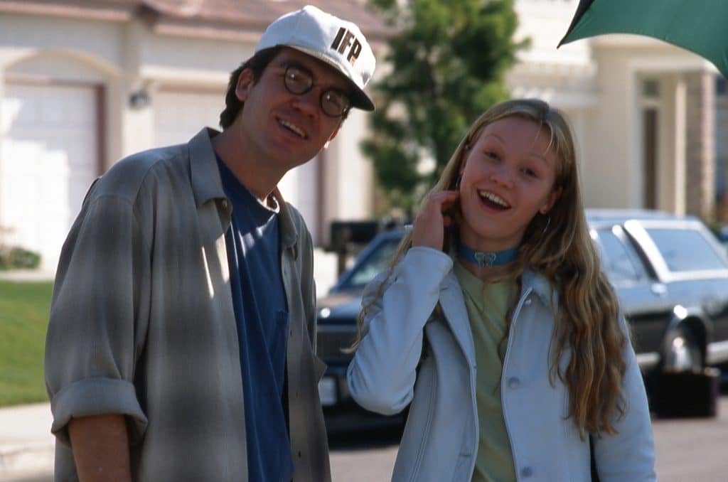 Photograph of director Michael Steinberg and actor Julia Stiles smiling on the set of the 1998 thriller "Wicked". 