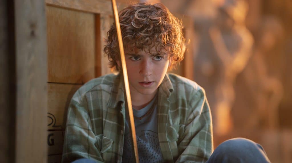 Still image of Walker Scobell as Percy Jackson holding a sword, from the Disney Plus fantasy series "Percy Jackson and the Olympians", based on the book series of the same name by Rick Riordan.