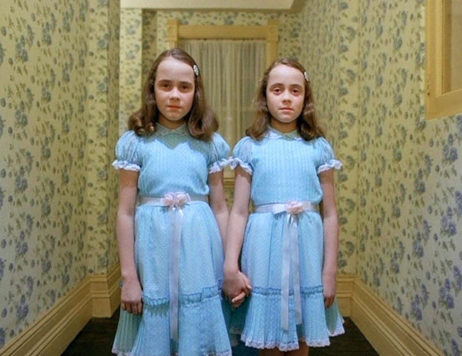 Still image of Lisa and Louise Burns as the Grady twins in Stanley Kubrick's 1980 psychological horror film "The Shining". 