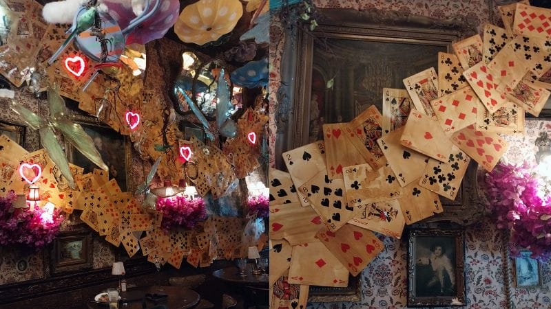 Images from the "Alice in Wonderland" instillation at the Oscar Wilde restaurant in New York City, featuring playing cards, hearts, and mushrooms hanging on the wall.