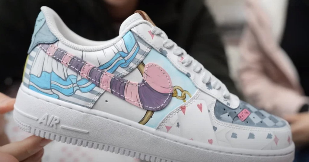 Image of a Nike Air Force One decorated in an "Alice in Wonderland" motif by artist MARKO. 