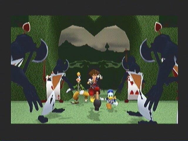 Image from the video game "Kingdom Hearts" featuring Card Soldiers, Donald Duck, and Goofy. 