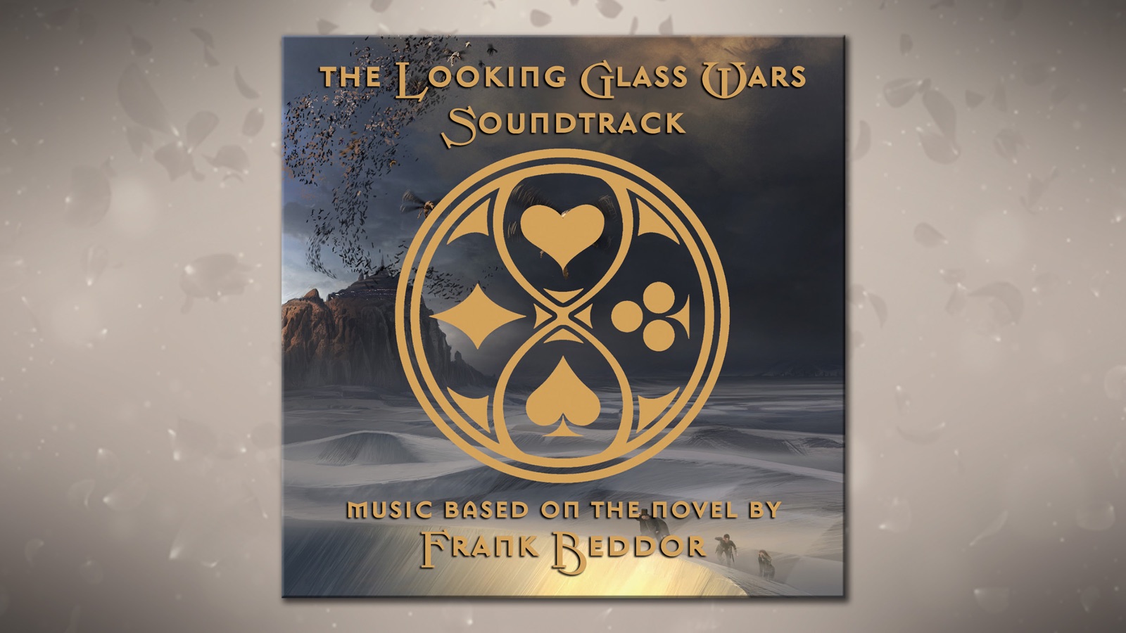 The soundtrack sleeve on a pale grey ground. Gold
                      lettering reads The Looking Glass Wars Soundtrack, over a
                      gold emblem that gathers the four card suits into one
                      circular device. Behind it, a snowbound Wonderland with a
                      rock fortress on the left and small figures crossing the
                      drifts. Along the foot: music based on the novel by Frank
                      Beddor.