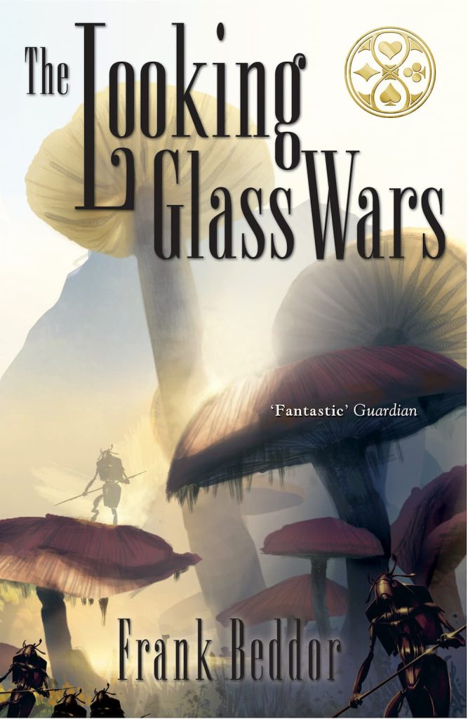 The UK Paperback cover of the Looking Glass Wars designed by Brian Flora. Massive mushrooms are backlit by golden light as mechanical card soldiers march under the canopy of mushrooms.