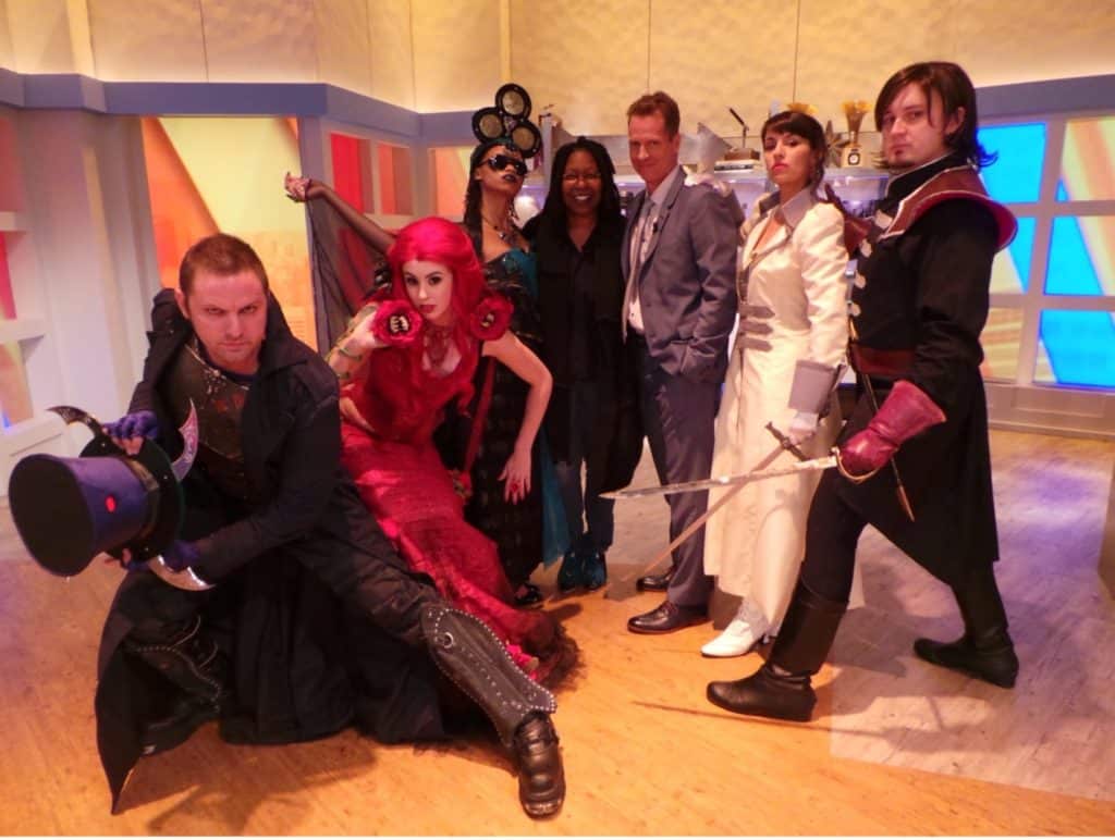 The Mad Hatter, brought to life by Chad Evett's costume and makeup, is conferring with Frank Beddor,and others on the set of The View with Whoopi Goldberg.