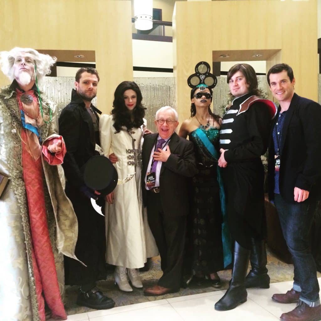 Chad Evett and a group of characters dressed in Looking Glass Wars costumes on the set of ConMan, a Syfy original series produced by Redbear Films.