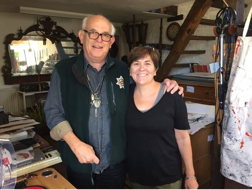 Wendy and Ralph Steadman smiling, standing in his art studio