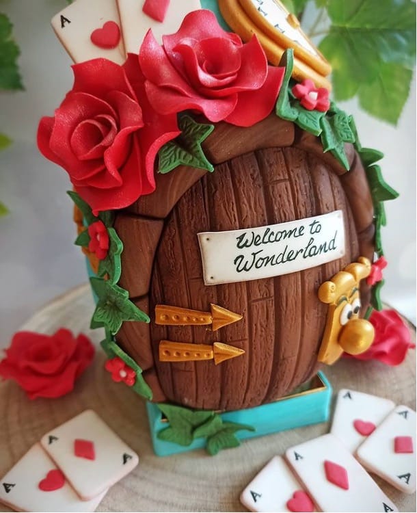 A decoraive icing egg created with Red Roses, playing cards, and the talking Door Knob from Disney's Alice in Wonderland