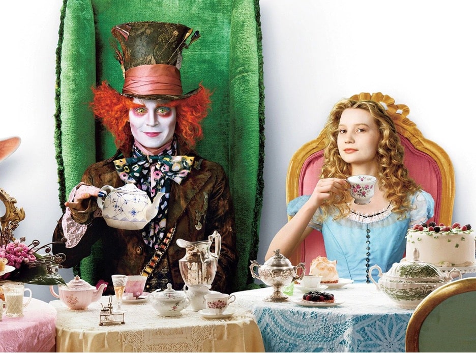 Mad hatter and Alice pose at a tea party for the 2010 Alice In Wonderland from Disney