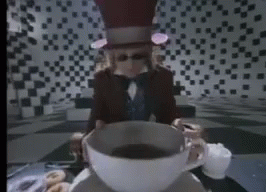 Tom-Petty-Video-for-the-song-Don't-Come-Around-Here-No-More-where-Tom-plays-the-Mad-Hatter-dropping-a-sugar-cube-into-a-large-cup-of-tea-with-Alice-splashing-around-in-it