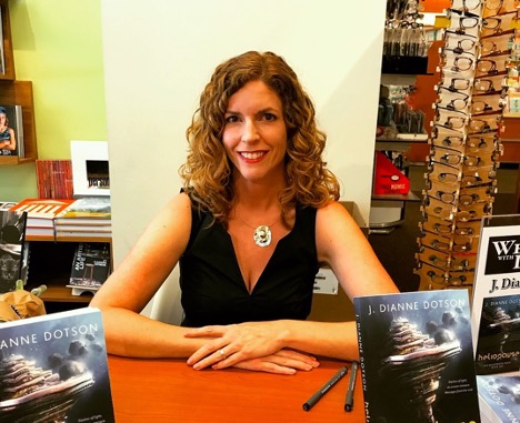 Image of J. Dianne Dotson, or Jendia Gammon sitting in a book store at a book signing event. 