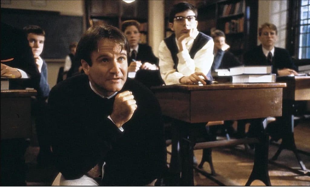 Actor, Robin Williams, sitting in a classroom in a scene from the film: Dead Poets Society. 
