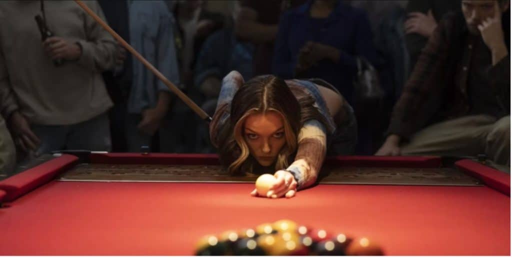 A photo from the new film Double Down South, directed by Tom Schulman. Lili Simmons leans over the table to make a shot while playing Keno Pool.