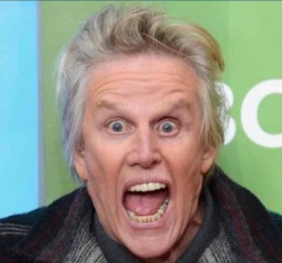 Image of American actor: Gary Busey with his mouth open. Looking crazy as always, he would be a good fit to cast as the Chesire Cat in a remake of the Alice in Wonderland TV movie. 
