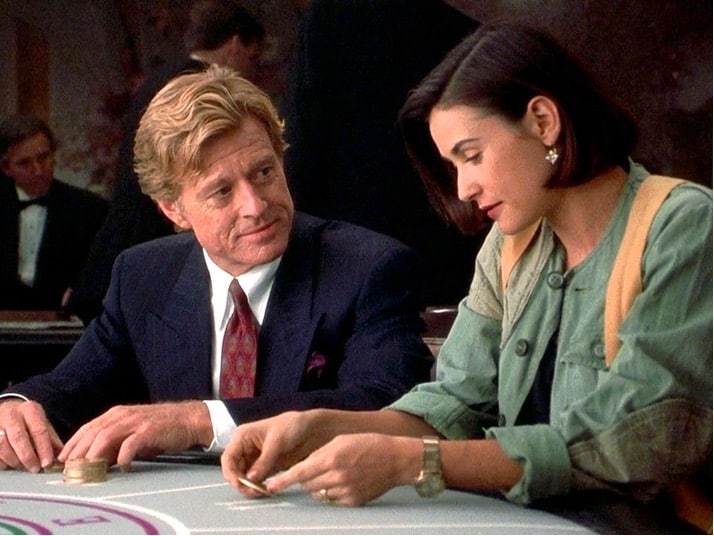 Image from a scene in the movie: Indecent Proposal, featuring Robert Redford and Demi Moore playing poker. 