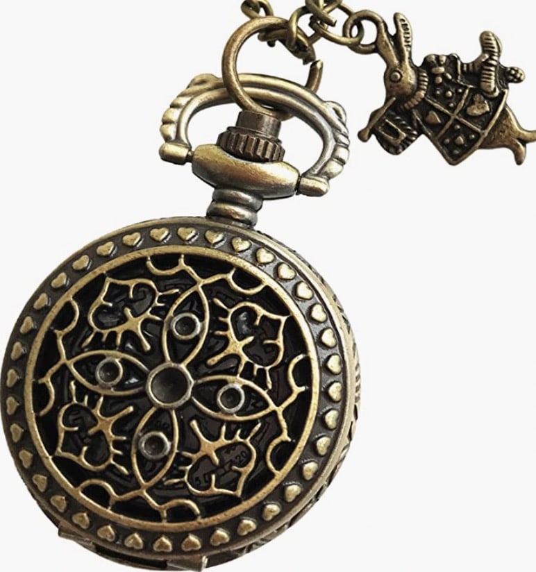 A tiny pocket watch in brass with a white rabbit charm