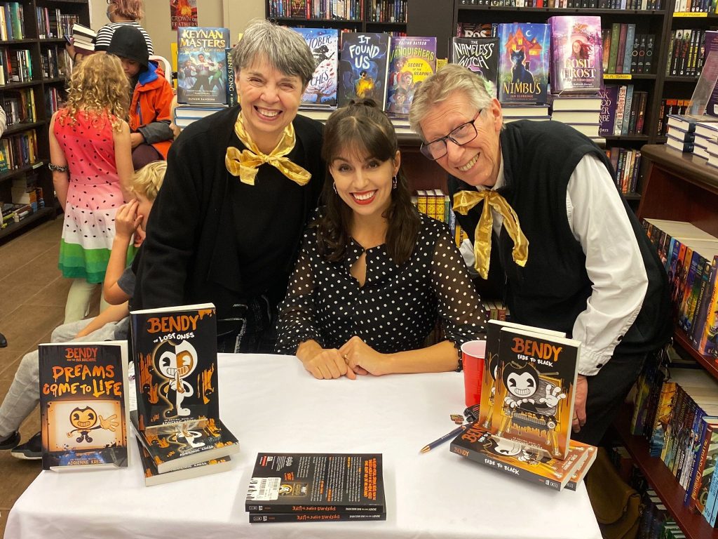 Author Adrienne Kress at a book signing event with her parents. 