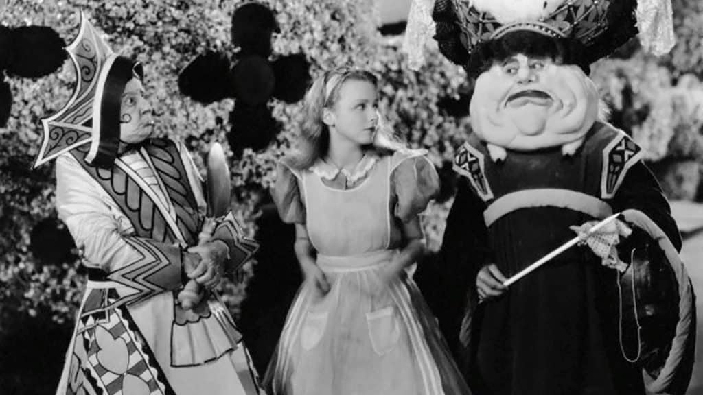 Still image from the 1933 Paramount film "Alice in Wonderland" featuring Alice and the King and Queen. 