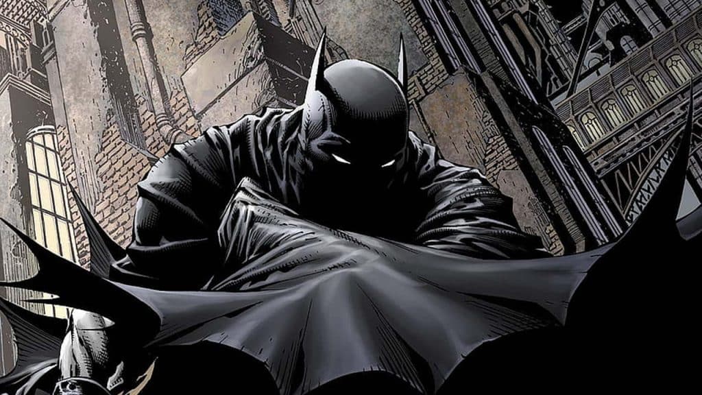 Illustration of Batman wrapped in his cloak on a building in Gotham City. 