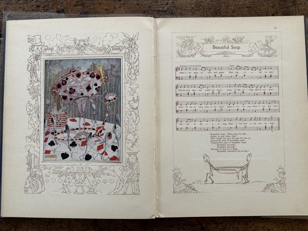 Pages from "Songs from 'Alice in Wonderland' and 'Through the Looking-Glass'". One has an image of a teacup with legs decorated in red and black card suits. The other page features sheet music. 