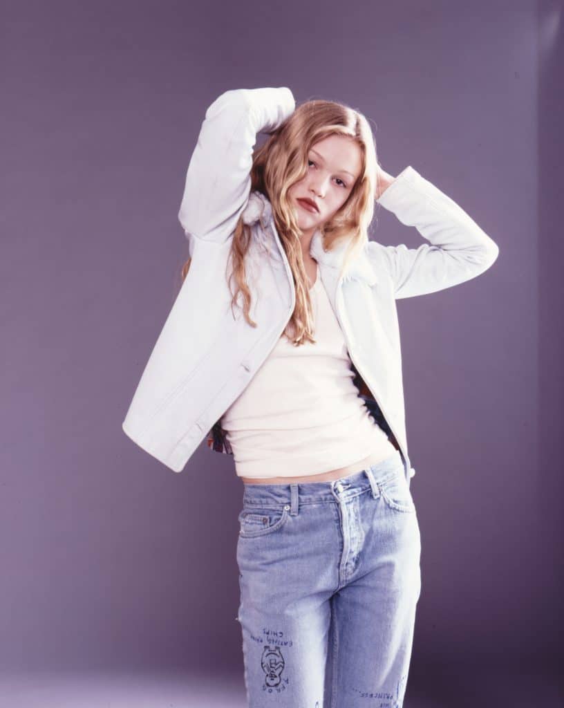 Publicity photograph of Julia Stiles, wearing a white jacket and jeans, for the 1998 thriller "Wicked". 