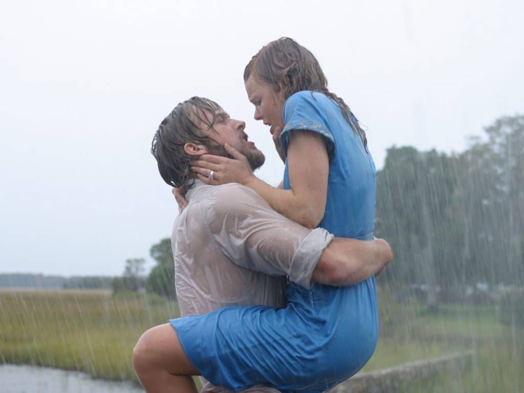 Ryan Gosling and Rachel McAdams as Noah and Allie, embracing in the rain, in the 2004 romance film "The Notebook".