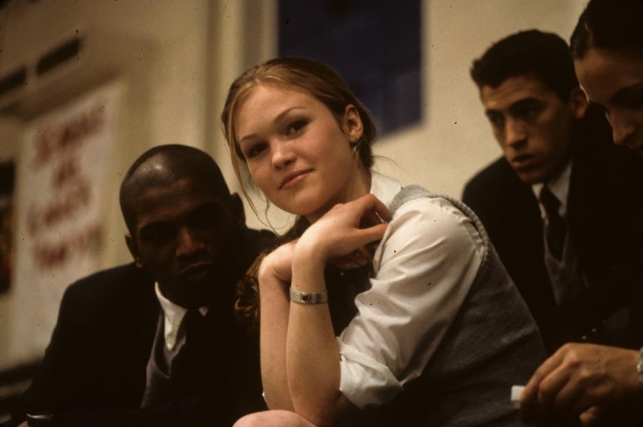 Still image of Julia Stiles and Mekhi Phifer sitting in a high school gym from the 2001 romantic thriller film "O".
