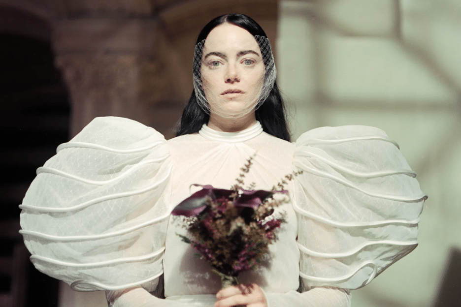 Still image of Emma Stone as Bella Baxter in a white dress from Yorgos Lanthimos' "Poor Things". 