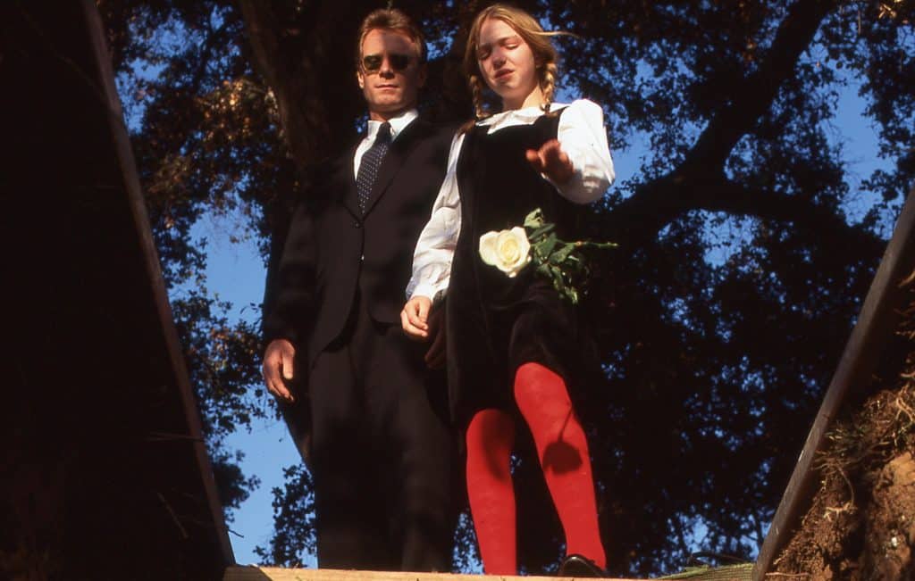 Still image from the thriller movie "Wicked" featuring William R. Moses and Vanessa Zima looking into a grave.  