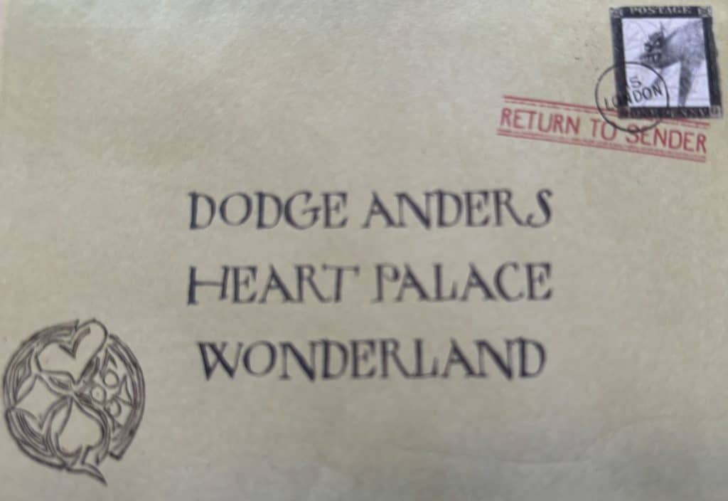 Image of an envelope addressed to Dodge Anders bearing a drawn Wonderland seal, inspired by the young adult fantasy novel "The Looking Wars" by author Frank Beddor. 
