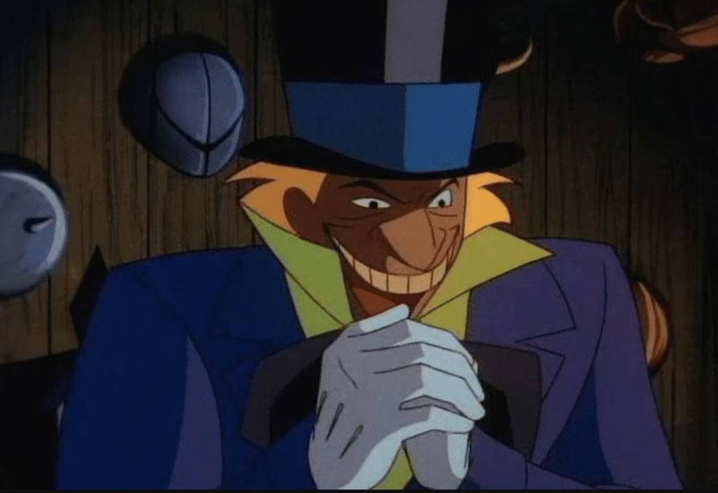 Still image from the animated show "Batman: The Animated Series" featuring Jervis Tetch/the Mad Hatter with his hands clasped and a maniacal grin.