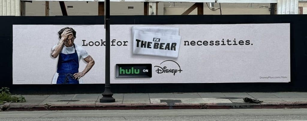 Disney Plus and Hulu billboard featuring Jeremy Allen White as Carmy Berzatto from the Hulu comedy-drama series "The Bear".