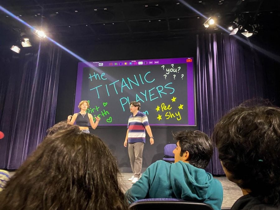 Photograph from a show put on by the improv group The Titanic Players of Northwestern University featuring two actors on stage. 