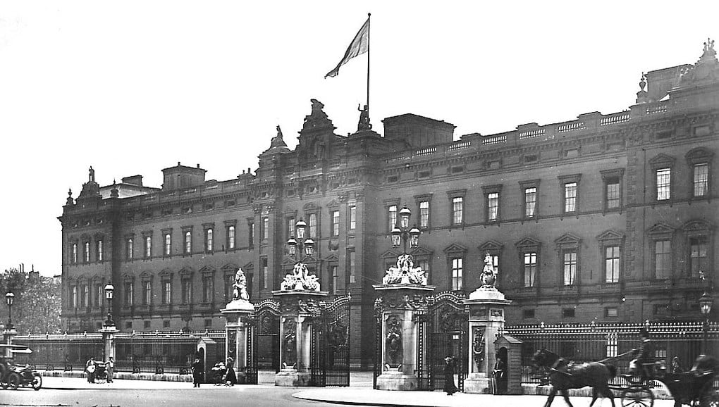A Victorian-era photograph of the facade and front gate of Buckingham Palace in London, United Kingdom. 