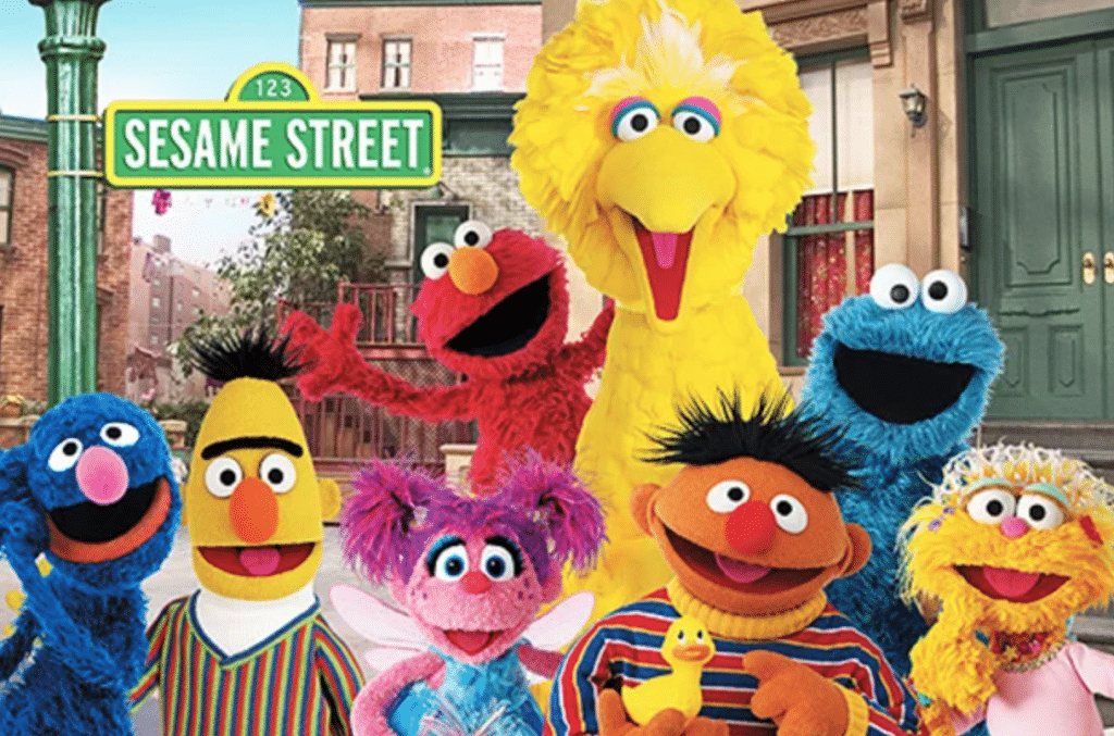 A promotional image for the PBS show "Sesame Street" featuring Elmo, Big Bird, Cookie Monster, and Bert and Ernie. 