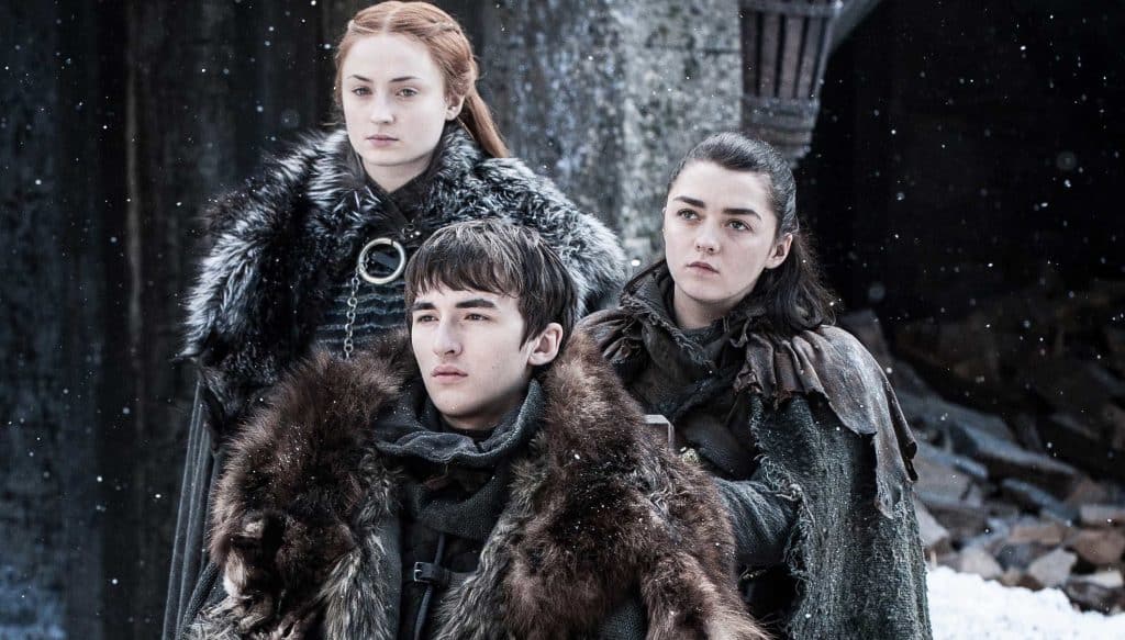 Still image from the HBO fantasy series "Game of Thrones" featuring Sophie Turner as Sansa Stark, Maisie Williams as Arya Stark, and Isaac Hempstead Wright as Bran Stark.