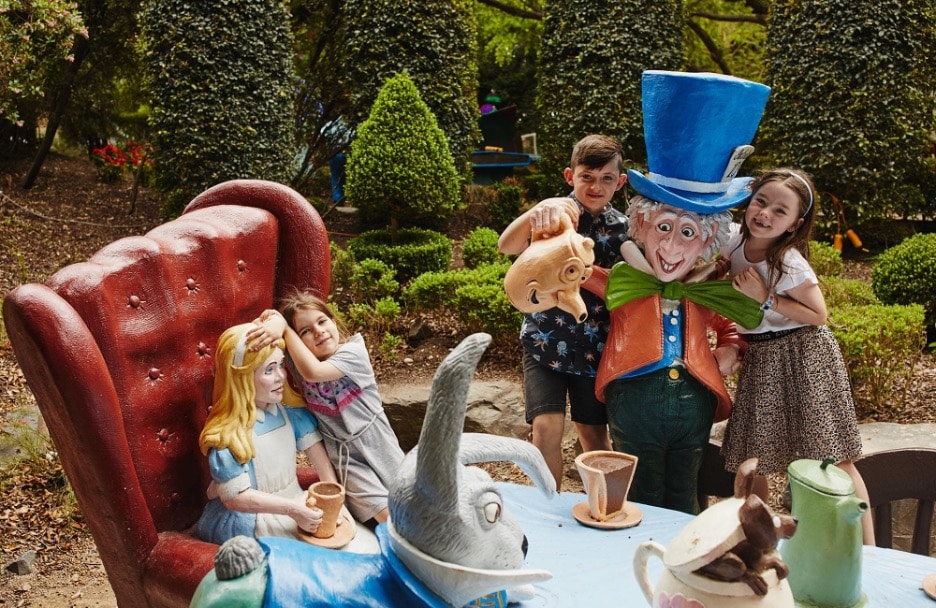 Life-sized statues of Alice, the Mad Hatter, and the March Hare at the Mad Hatter's Tea Party from the Storybook Garden installation at the Hunter Valley Gardens in Sydney, Australia. 