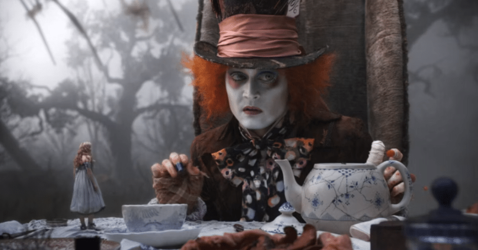 Still image of Johnny Depp as Tarrant Hightop/Mad Hatter having tea from Tim Burton's 2010 film "Alice in Wonderland".