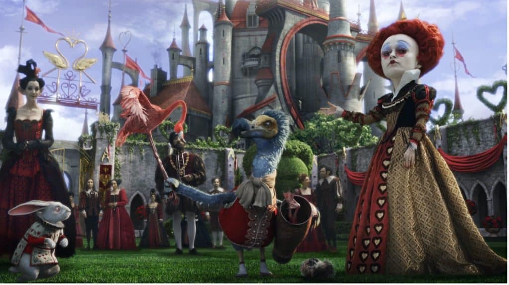 Still image of Helena Bonham Carter as Iracebeth/Red Queen flanked by magical creatures and a castle from Tim Burton's 2010 film "Alice in Wonderland". 