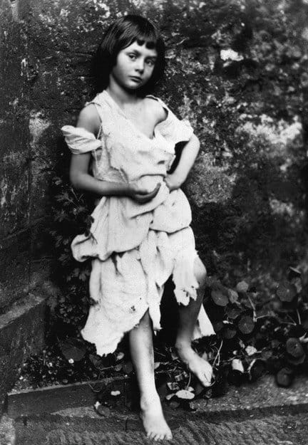 Black-and-white photograph of six-year-old Alice Liddell, the purported inspiration for "Alice's Adventures in Wonderland," taken by Lewis Carroll in 1858.