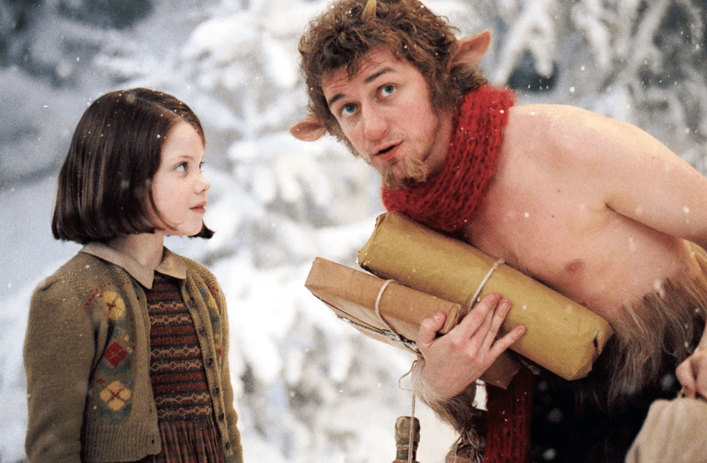 Still image from the 2005 high fantasy film "The Chronicles of Narnia: The Lion, the Witch, and the Wardrobe" featuring Georgie Henley and James McAvoy as Mr. Tumnus the fawn. 