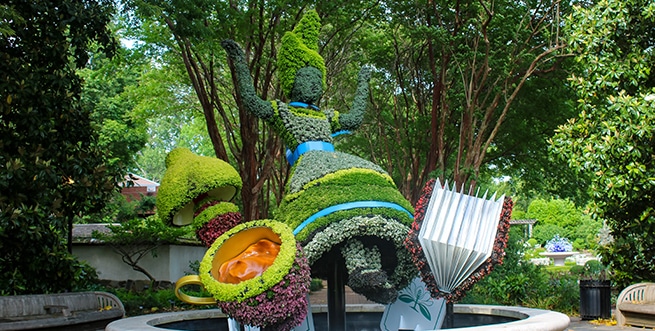 A topiary sculpture depicting Alice falling down the rabbit hole from "Alice in Wonderland" in the Atlanta Botanical Garden.