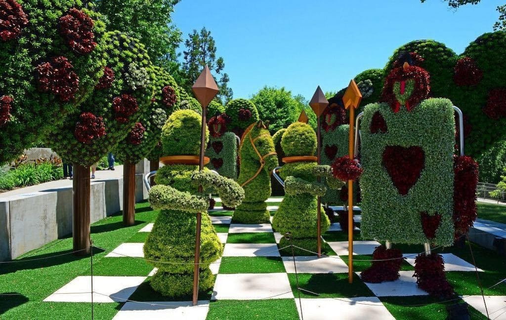 A topiary sculpture depicting the card soldiers and chessboard from "Alice in Wonderland" in the Atlanta Botanical Garden.