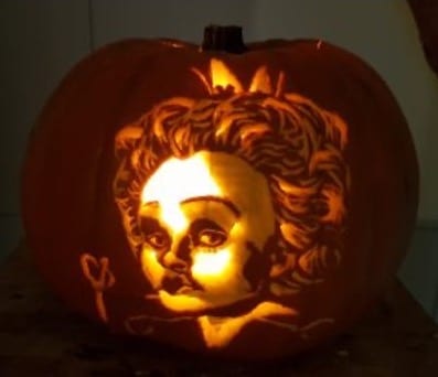 A photograph of a pumpkin carved to depict Helen Bonham Carter as Iracebeth/Red Queen from Tim Burton's 2010 film "Alice in Wonderland". 